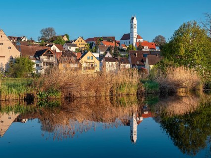 The old town centre with the Herz Jesu church is reflected in the River Wörnitz, Harburg,