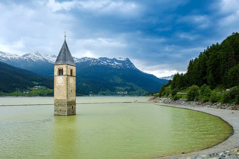 Bell tower of the former parish church of St Catherine in the sunken village of Alt-Graun in Lake
