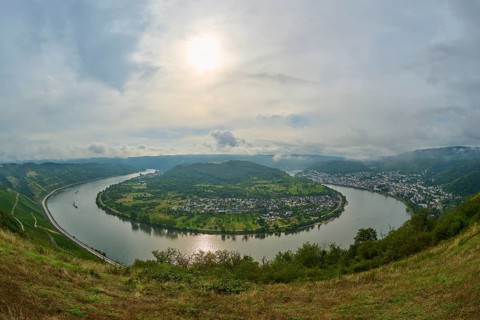 Impressive river landscape with valley, hills and cloudy sky in sunshine, summer, Rhine bend