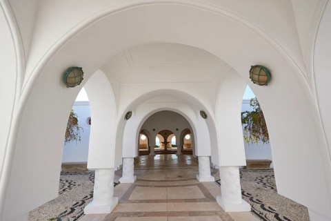 A bright corridor with white arches and decorative floor mosaic, Kalithea, Kallithea, thermal