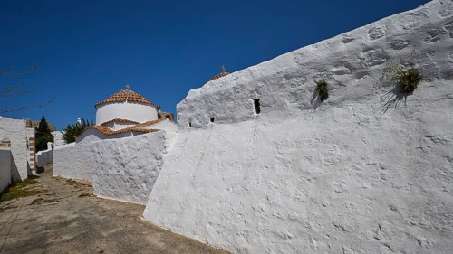 Church of Agia Kioura, White monastery wall under a blue sky, simple and traditional, Church,