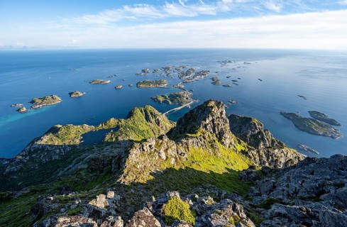 View of numerous small rocky islands with houses, at the summit of Festvågtind, view of