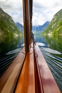 Mountains and lake reflected in the windscreen of the excursion boat at Königssee, Berchtesgaden