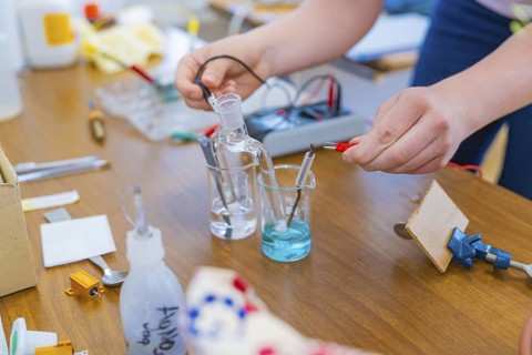 Chemistry laboratory with electrodes in liquid beakers on a table, Battery Research, Nagold,