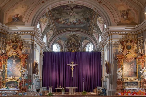 Side altars and large purple Lenten cloth in front of the high altar, baroque parish church of St