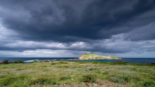 Coast and dark storm clouds near Port de Centuri, Cap Corse, Haute-Corse, Corsica, France