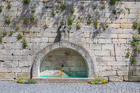 Town wall with a fountain on Marienplatz in Kronach, Germany