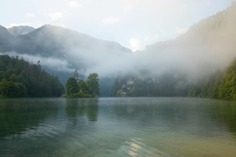 Mystical morning at Königssee in Schönau with boathouses and Christlieger. Sunrise and beautiful