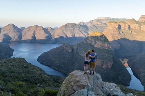 Two hikers enjoying panorama, Blyde River Canyon with Three Rondawels peak, view of gorge with