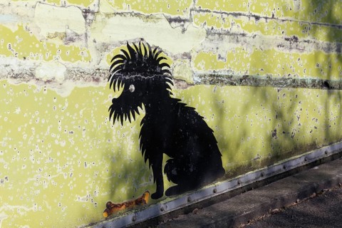 Black dog with bone, funny mural at Cologne Zoo car park, graffiti, Cologne, North