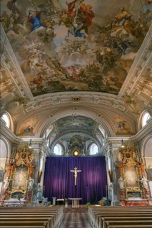 Interior with large purple Lenten cloth in front of the high altar, baroque parish church of St