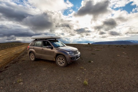 SUV, SUV with roof tent parked next to gravel road F35, Kjalvegur Kjölur, barren stony volcanic