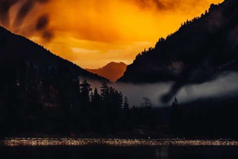 Surreal light atmosphere at sunrise at Plansee, Tyrol, in the Alps in Austria