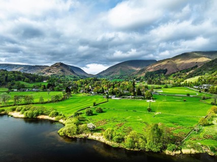 Farms and Mountains over road A591 from a drone, Grasmere Lake, Grasmere, Ambleside, Lake District,