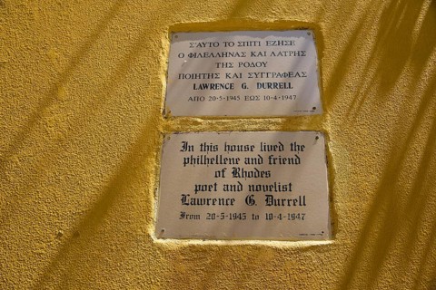 House of Lawrence Durrell, memorial plaques on a yellow wall with quotes by Lawrence G. Durrell,