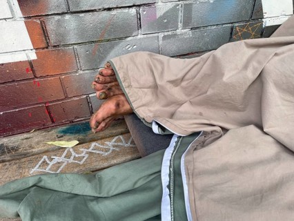 Homeless man sleeping on a bench, Yorkstrasse corner Möckernstrasse, Friedrichshain-Kreuzberg