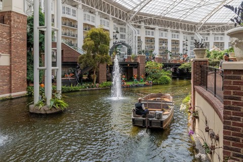 Guide piloting boat through the canal inside the Gaylord Opryland Resort and Convention Center in