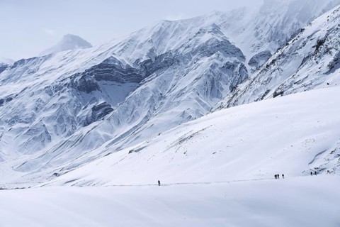 People walking through the snow, in the high mountains, Himalayas, Spitital, Kaza, Himachal