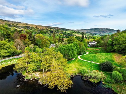 Farms and Mountains over road A591 from a drone, Grasmere Lake, Grasmere, Ambleside, Lake District,