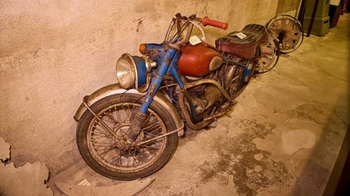 An old, dusty motorbike on display in a bunker, War Museum, Military Museum, Tunnel Museum, Lakki,