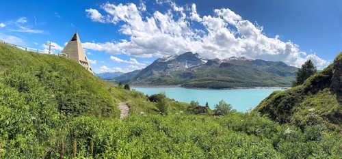 Panoramic view from plateau above Lanslebourg-Mont-Cenis to reservoir Lac du Mont Cenis left Museum