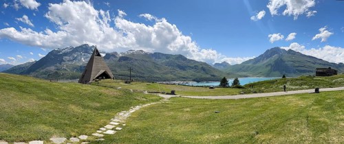 Panoramic view from plateau above Lanslebourg-Mont-Cenis to reservoir Lac du Mont Cenis left Museum