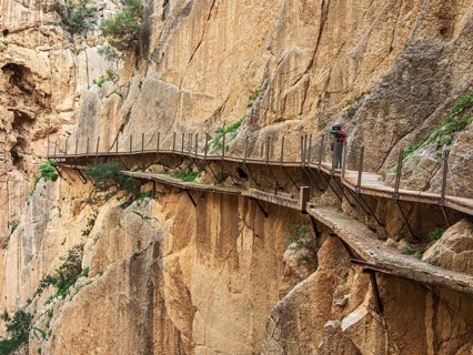 Tourists on the elevated path of the caminito del rey, along a deep gorge, Andalusia, Spain