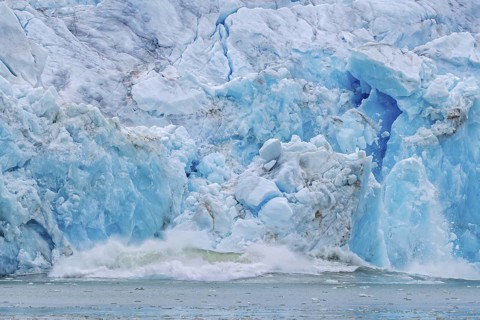 Collapsing ice wall of Fjortende Julibreen, 14th of July Glacier calving into Krossfjorden, Haakon