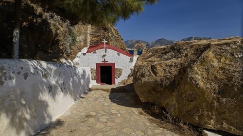 Legend, crab, shell fisherman, chapel with red roof and sea view on a rocky coast, in natural and