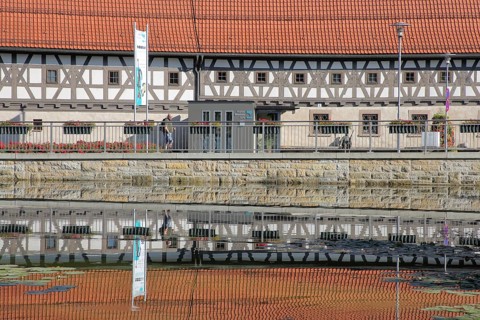 Armoury museum built in 1668 with reflection, half-timbered house, pond, bank, Suhl, Franconia,