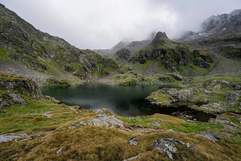 Mountain lake Kreuzsee, cloudy mountain peaks, Schober group, Hohe Tauern National Park, Carinthia,