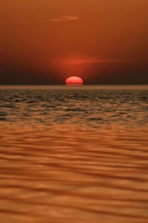 When the red sun sinks into the sea... Cuxhaven, North Sea, sunset in calm weather, glowing red