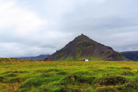 Cone-shaped mountain Stapafell, rain clouds, Arnarstapi, Faxafloi, Snæfellsnes peninsula,
