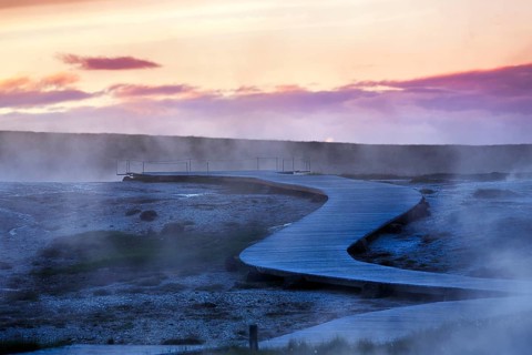 Curved wooden path, sulphur vapour, Hveravellir geothermal area, evening sky, Icelandic highlands,
