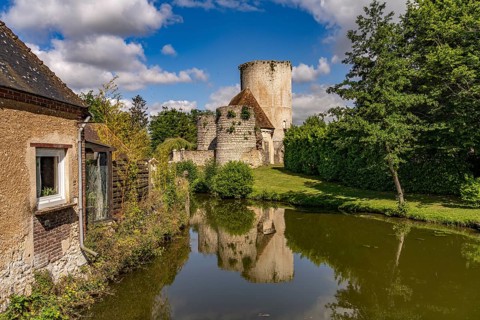 The river Loir and the castle with donjon in Alluyes, Centre-Val de Loire, France