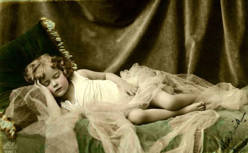 Girl sleeping, 1920, A child sleeping peacefully in a bed with tulle, Historical photo