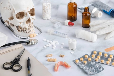 Medical utensils, tablets with skull and teeth
