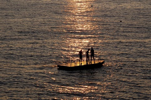 Children playing on bathing island, bathing raft, swimming island, Étretat, sea, sunset, evening