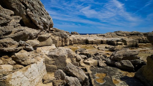 Rough rocky terrain with a view of the sea in sunny weather, Oasis Beach, east coast of Rhodes,