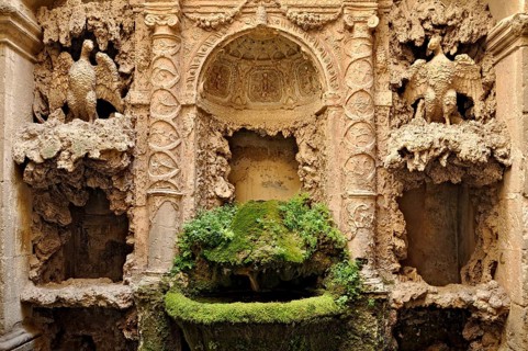 Ornamental fountain from the Renaissance, fountain with moss and artificial dripstone from the