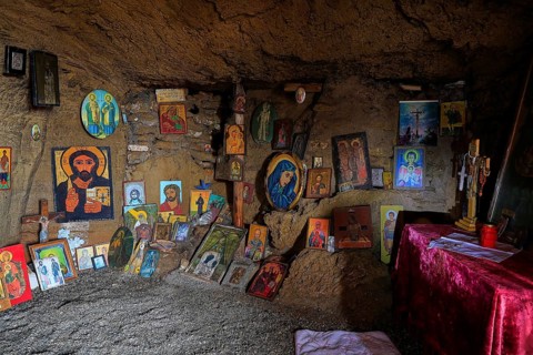 Cave with religious icons and altar table, spiritual atmosphere, chapel, Agios Nikolaos, rock