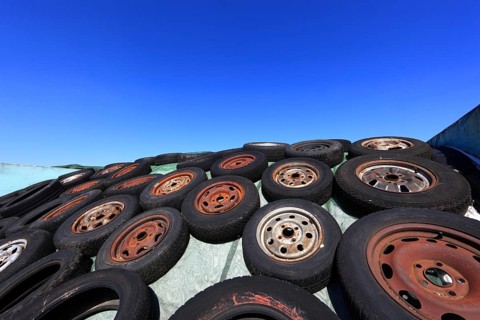 Old wheels, rims and tyres, used here to weigh down the cover of an agricultural silo