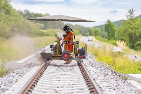 A worker carries out welding work with machines on a railway track, grinding work on the Hermann