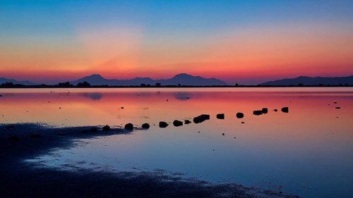 Varied colours during sunset over a calm lake, salt lake, Tigaki, nature reserve, hydro biotope,