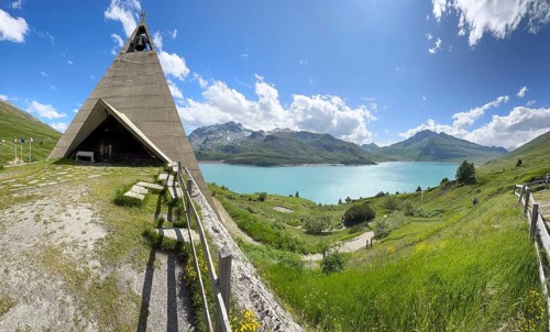 Panoramic photo with Mont-Cenis Pyramid Museum built in 1967 on the left above Lac du Mont Cenis on