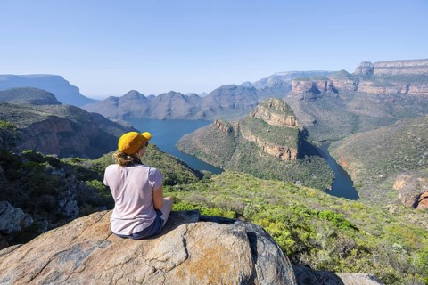 Hiker enjoying panorama, Blyde River Canyon with summit Three Rondawels, view of canyon with river