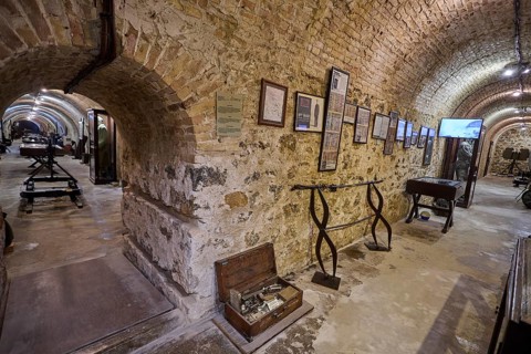 Historic cellar room with stone walls, exhibits and antique documents, war museum, military museum,