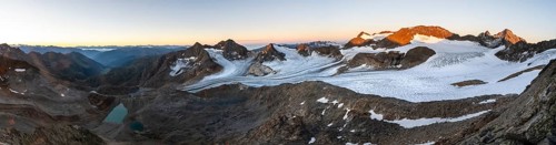 Panorama at sunrise with alpenglow, high mountain landscape, view of blue glacial lakes, mountain