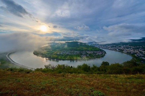River landscape in peaceful morning mood, with clouds and gentle sun over hills, summer, Rhine bend