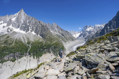 Picturesque mountain landscape of imposing mountain peaks and glaciers, mountaineer on hiking